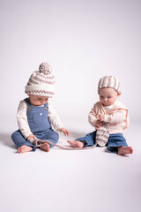 Two babies in front of a white background  wearing a striped crochet hat and striped crochet headband. thumbnail