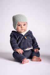 baby wearing knit hat in front of white background thumbnail