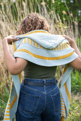Woman wearing yellow and blue hooded scarf back view thumbnail