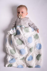 baby posing with granny square blanket wrap made with green blue and white yarns thumbnail