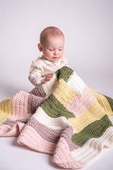 baby with multicolor log cabin crochet blanket in front of white background thumbnail