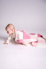Knit gingham blanket in pink and white with baby  thumbnail