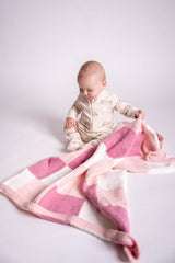 Knit gingham blanket in pink and white with baby  thumbnail