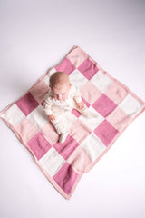 Knit gingham blanket in pink and white with baby  thumbnail