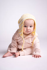 baby wearing white and yellow baby hat with ear flaps thumbnail