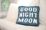 blue knit pillow with glow in the dark white letters that spell Good Night Moon thumbnail
