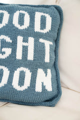blue knit pillow with glow in the dark white letters that spell Good Night Moon thumbnail