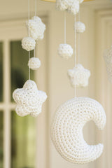 close up of a moon, star, and ball shape for a crochet mobile thumbnail