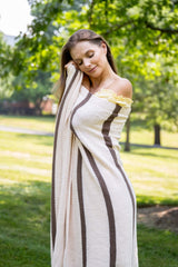 Woman wrapped in cream and brown stripped throw thumbnail