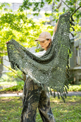 woman holding a  fringed shawl behind her back thumbnail