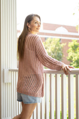 back view of woman wearing pink crochet cardigan thumbnail