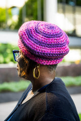 Woman wearing purple and pink striped beret thumbnail