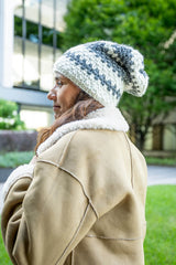 Woman wearing a light blue and medium blue striped hat thumbnail
