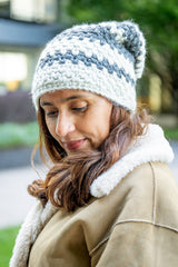 Woman wearing a light blue and medium blue striped hat thumbnail