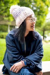woman wearing knit hat with pom thumbnail