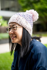 woman wearing knit hat with pom thumbnail