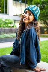 Woman wearing knit hat with blue stripes thumbnail