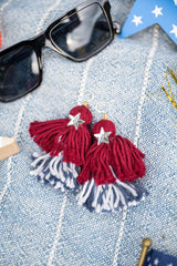 tassel earrings on blue background thumbnail