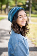 person wearing a blue knit hat denim jacket and white shirt outdoors thumbnail