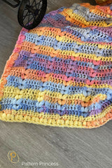 crocheted baby blanket made with pastel yarn with colorful shades thumbnail