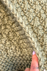close-up of sage green knitted seersucker blanket edge showing textured stitch pattern and garter stitch border thumbnail