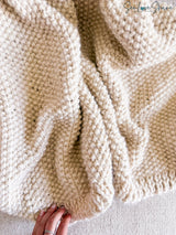 whipped cream colored knitted blanket highlighting seed stitch texture thumbnail