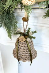 crocheted holiday bell ornament door hanger with green ribbon and evergreen sprigs thumbnail
