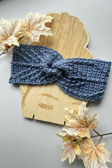 blue crocheted headband styled on a wooden display with sunglasses thumbnail