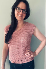 Woman with her hand on her hip wearing a crochet top thumbnail