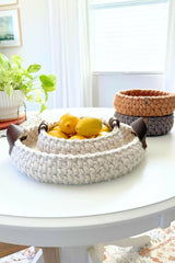 crochet baskets on a table, one with lemons in it thumbnail