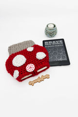 red toadstool mushroom-shaped crocheted sleeve next to kindle thumbnail
