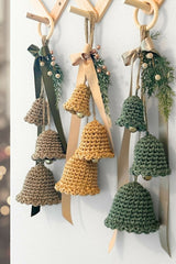 Crocheted holiday bell ornament door hangers with green ribbon and evergreen sprigs thumbnail