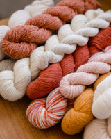 Image of multiple skeins of yarn in different hues, weights and textures. thumbnail
