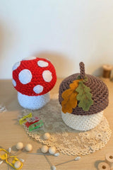 handmade crochet mushroom and acorn on a wooden table thumbnail