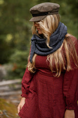 Woman wearing knit scarf in woods thumbnail