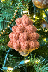 handmade bobble stitch Christmas tree ornament hanging on a tree thumbnail