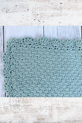 crochet blanket on a wood background thumbnail