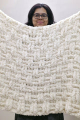 Woman holding cream colored crochet blanket thumbnail