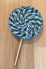 Blue jumbo lollipop craft on wood floor thumbnail