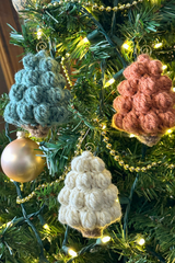 three handmade bobble stitch Christmas tree ornaments hanging on a tree thumbnail