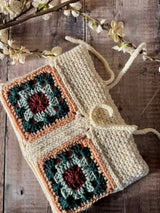 handmade crochet hearthside book sleeve on a wooden surface thumbnail