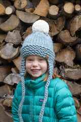 Knitted Ear Flap Hat Worn By A Child thumbnail