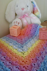 shell stitch crochet blanket with bunny stuffed animal and blocks thumbnail