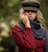 Woman wearing knit scarf in woods thumbnail