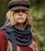 Woman wearing knit scarf in woods thumbnail