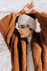 woman wearing a cream crocheted knit-look ear warmer headband with a cozy teddy jacket outdoors thumbnail