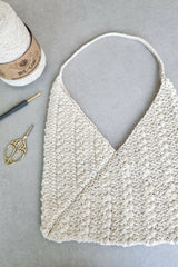 ecru bag laying next to crochet hook and yarn thumbnail