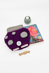 purple toadstool mushroom-shaped crocheted sleeve next to kindle reader thumbnail