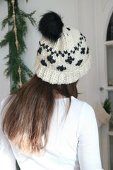 woman wearing a cream and black houndstooth knitted beanie thumbnail