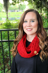 red crocheted tulip stitch cowl with brown wooden buttons worn by a smiling woman outdoors thumbnail